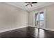 Bedroom with dark hardwood floors and glass doors leading to a balcony with a water view at 2937 Butler Bay N Dr, Windermere, FL 34786