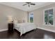 Bedroom with dark hardwood flooring, neutral walls, and a beautiful outdoor view from windows at 2937 Butler Bay N Dr, Windermere, FL 34786