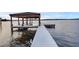 A modern boat dock extends into calm waters, offering serene waterfront living at 2937 Butler Bay N Dr, Windermere, FL 34786