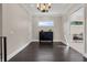 Bonus room with wood flooring, neutral walls, black dresser, chandelier, and access to another room at 2937 Butler Bay N Dr, Windermere, FL 34786