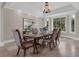 Formal dining room boasting a tray ceiling, large window, and elegant furnishings at 2937 Butler Bay N Dr, Windermere, FL 34786
