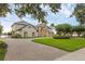 Elegant home featuring a brick driveway and well-manicured lawn at 2937 Butler Bay N Dr, Windermere, FL 34786