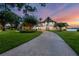 A beautiful home with a curving driveway, mature trees, and a peaceful view of the lake at 2937 Butler Bay N Dr, Windermere, FL 34786
