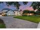 An impressive estate home with a circular driveway, lush landscaping, and a tranquil water fountain at 2937 Butler Bay N Dr, Windermere, FL 34786