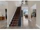 Elegant foyer with a grand staircase, tile flooring, and views to the living room at 2937 Butler Bay N Dr, Windermere, FL 34786