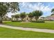 Beautifully landscaped front yard with mature trees and circular driveway at 2937 Butler Bay N Dr, Windermere, FL 34786