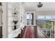 Hallway featuring built in bookshelf, red rugs, hardwood floors, and water view at 2937 Butler Bay N Dr, Windermere, FL 34786