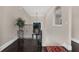 Bright hallway with decorative plant, dark wood floors, and wrought iron railing at 2937 Butler Bay N Dr, Windermere, FL 34786