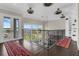 Hallway boasts railing, water view, red rugs, white walls, and multiple ceiling fans at 2937 Butler Bay N Dr, Windermere, FL 34786