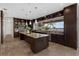 Gourmet kitchen boasts an island, granite countertops, stainless appliances, and water views through a large window at 2937 Butler Bay N Dr, Windermere, FL 34786