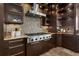 Custom kitchen with stainless steel range hood and mosaic tile backsplash with granite countertops at 2937 Butler Bay N Dr, Windermere, FL 34786