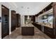 Modern kitchen features a large island, wine fridge, custom cabinets, and stainless steel appliances at 2937 Butler Bay N Dr, Windermere, FL 34786