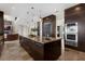 Gourmet kitchen features a large island, stainless steel appliances, custom cabinetry, and travertine flooring at 2937 Butler Bay N Dr, Windermere, FL 34786