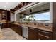 Kitchen boasts stainless steel appliances, granite countertops, and a large window with beautiful water views at 2937 Butler Bay N Dr, Windermere, FL 34786