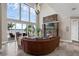 Light-filled living room with a stone fireplace, scenic lake views, and comfortable seating arrangements at 2937 Butler Bay N Dr, Windermere, FL 34786