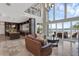Spacious living room with soaring ceilings, large windows with waterfront views, and open kitchen access at 2937 Butler Bay N Dr, Windermere, FL 34786