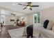 Bright main bedroom boasts a seating area, ceiling fan, and beautiful natural light at 2937 Butler Bay N Dr, Windermere, FL 34786