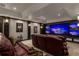 Cozy media room with tiered seating, wet bar, and multiple screens at 2937 Butler Bay N Dr, Windermere, FL 34786