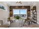 Bright office space with stone accent wall, desk, chairs, and large sliding doors opening to a lake view at 2937 Butler Bay N Dr, Windermere, FL 34786