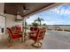 Covered outdoor dining area with a view of the water and a built-in grill at 2937 Butler Bay N Dr, Windermere, FL 34786