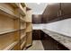 Organized pantry with granite countertops, custom cabinetry, and metal shelving for ample storage at 2937 Butler Bay N Dr, Windermere, FL 34786
