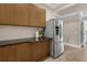 Pantry with stainless steel refrigerator and granite countertops at 2937 Butler Bay N Dr, Windermere, FL 34786