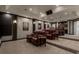 Home theater with leather reclining seats, tiered flooring, projector, and wet bar in the background at 2937 Butler Bay N Dr, Windermere, FL 34786