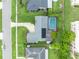 Aerial view of a well-maintained home with a private pool and solar panels nestled in a lush, green backyard at 3010 Brandywine Dr, Orlando, FL 32806