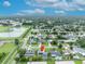 Drone image of residential area, marking the property location amidst lush greenery and a tranquil pond at 3010 Brandywine Dr, Orlando, FL 32806