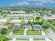Aerial view showing a property with well-maintained greenery near a scenic lake, outlined in yellow at 3010 Brandywine Dr, Orlando, FL 32806