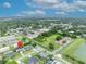 Aerial view of neighborhood homes with mature trees, highlighting the proximity to commercial area and city skyline at 3010 Brandywine Dr, Orlando, FL 32806