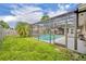 Landscaped backyard featuring a screened-in pool and lush greenery, creating a serene outdoor retreat at 3010 Brandywine Dr, Orlando, FL 32806