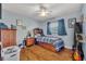Small cozy bedroom featuring a ceiling fan, wood floor and dark wood furniture at 3010 Brandywine Dr, Orlando, FL 32806