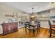 Cozy dining area features wood floors, table set for four, and access to an outdoor space through glass doors at 3010 Brandywine Dr, Orlando, FL 32806