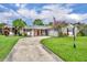 Welcoming single-story home boasting a driveway, an attached garage, and vibrant landscaping at 3010 Brandywine Dr, Orlando, FL 32806