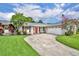 Well-maintained home featuring a curved driveway, an attached garage, an inviting entrance, and a lush green lawn at 3010 Brandywine Dr, Orlando, FL 32806