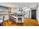 Bright kitchen features white cabinetry, stainless steel appliances, a kitchen island, and pendant lighting at 3010 Brandywine Dr, Orlando, FL 32806