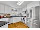 Bright kitchen with stainless steel appliances, white cabinetry, and a window above the sink at 3010 Brandywine Dr, Orlando, FL 32806