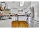 Well-lit kitchen with stainless appliances, white cabinets, and an open layout to dining area at 3010 Brandywine Dr, Orlando, FL 32806