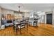 Open concept kitchen and dining area with stainless steel appliances, a kitchen island, and wood flooring at 3010 Brandywine Dr, Orlando, FL 32806