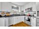 Bright kitchen with stainless steel appliances and ample counter space with a view from the window at 3010 Brandywine Dr, Orlando, FL 32806