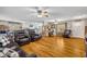 Expansive living area with wood floors, comfortable leather seating, and an open floor plan connecting to the dining and kitchen areas at 3010 Brandywine Dr, Orlando, FL 32806