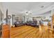 Inviting living room featuring wood floors, cozy seating, and an open layout that flows seamlessly into the kitchen and dining area at 3010 Brandywine Dr, Orlando, FL 32806