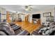 A spacious living room with wood floors, comfortable seating, and a television atop a stand at 3010 Brandywine Dr, Orlando, FL 32806