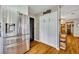 View of a stainless steel refrigerator and a pantry with bright light on wood floors at 3010 Brandywine Dr, Orlando, FL 32806