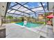 Backyard pool with screened enclosure featuring a basketball hoop, mature landscaping and a patio area at 3010 Brandywine Dr, Orlando, FL 32806