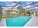 Beautiful backyard screened-in pool area with clear blue water and comfortable poolside seating at 3010 Brandywine Dr, Orlando, FL 32806