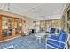 Spacious sunroom featuring a ceiling fan, blue tile floor, with sliding doors and lots of natural light at 3010 Brandywine Dr, Orlando, FL 32806