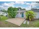 Backyard featuring a concrete patio, a well-maintained lawn, and lush green landscaping at 311 Cortland Ave, Winter Park, FL 32789