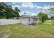 Back exterior view of gray single-story home with a fenced in yard and AC Unit at 311 Cortland Ave, Winter Park, FL 32789